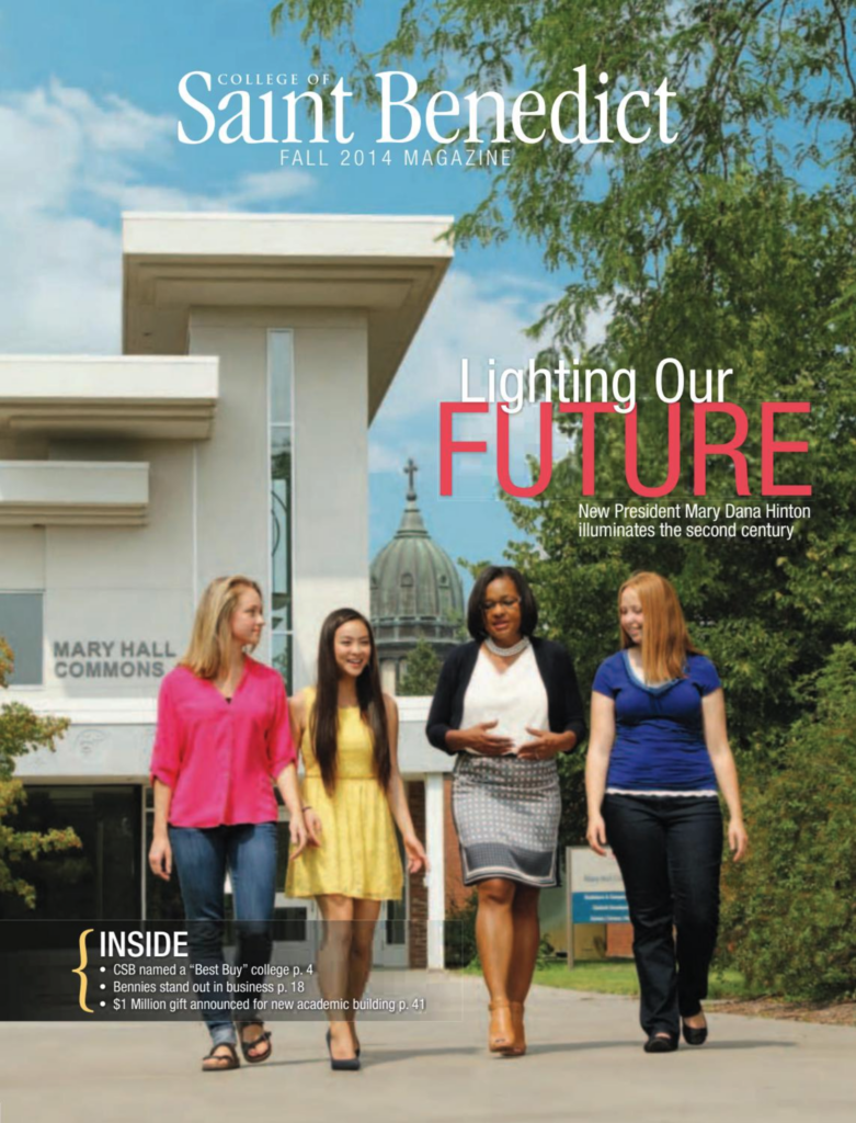 Four people walking together outside the Mary Hall Commons at the College of Saint Benedict. The cover of the Fall 2014 magazine reads "Lighting Our Future" with additional text about new leadership and featured articles inside.